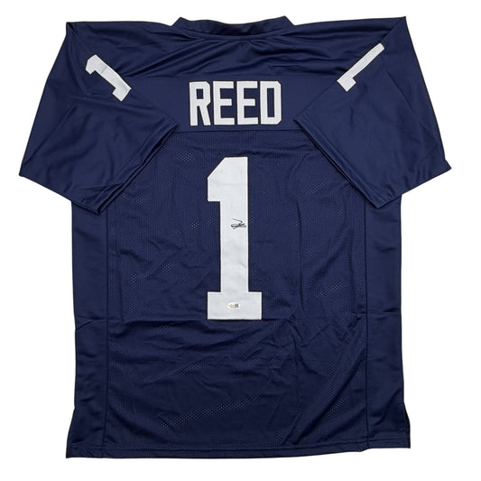 Navy blue Penn State football jersey with white "REED" nameplate and number "1" on back, displayed flat against white background.