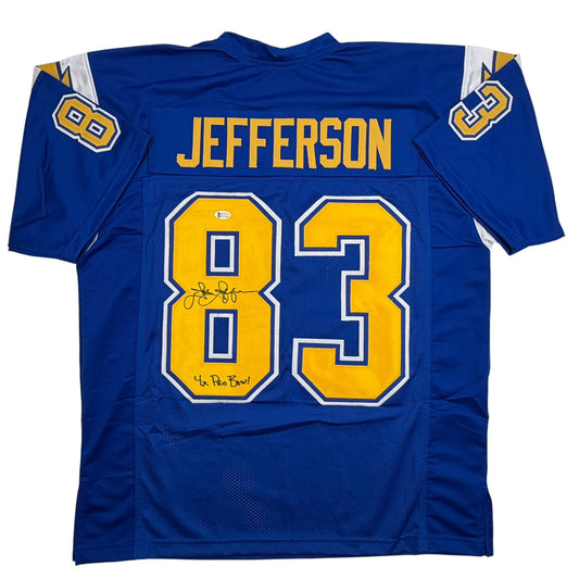 Back view of signed blue football jersey number 83 with "JEFFERSON" nameplate and yellow numbers, displaying autographs on the chest.