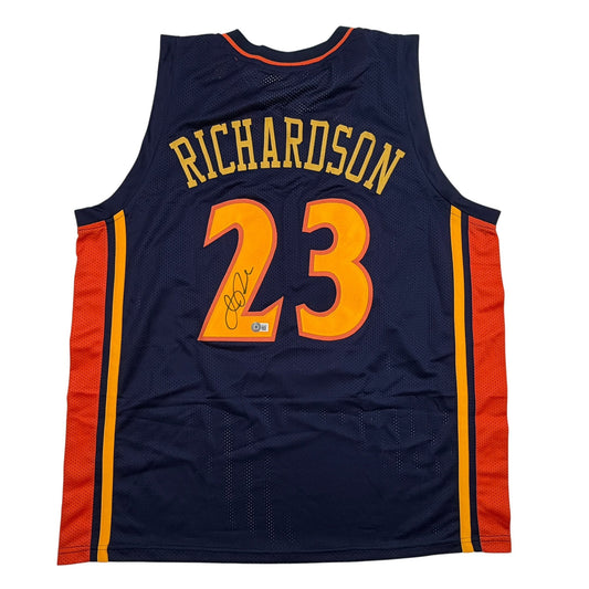 Back view of navy blue basketball jersey with "RICHARDSON" and number "23" in gold and orange lettering, red side panels, and autographed signature on the number.