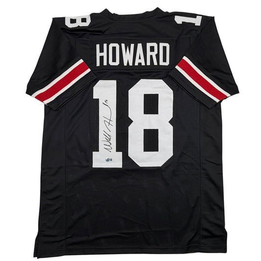 Black college football jersey with "HOWARD" and number 18 printed in white, featuring red and white sleeve stripes and an autographed signature.