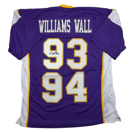 Back view of purple Minnesota Vikings jersey number 93/94 with "WILLIAMS WALL" nameplate and white trim, signed by Kevin Williams.