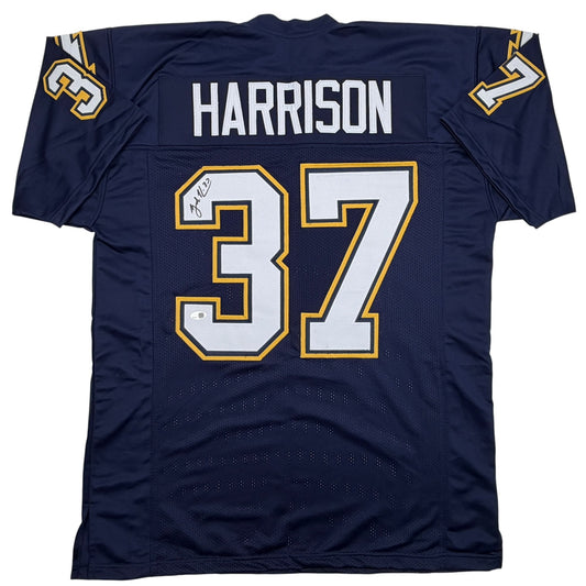 Back view of navy blue football jersey number 37 with "HARRISON" nameplate and gold/white trim, displaying autograph on number.