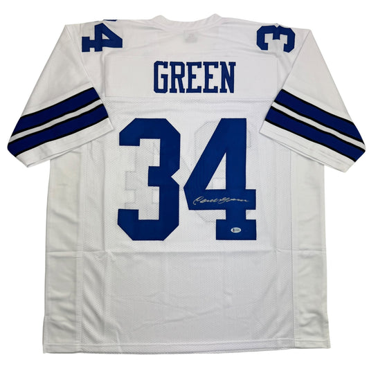 Back view of white Dallas Cowboys jersey number 34 with "GREEN" nameplate and blue numerals, featuring navy stripe on sleeves.