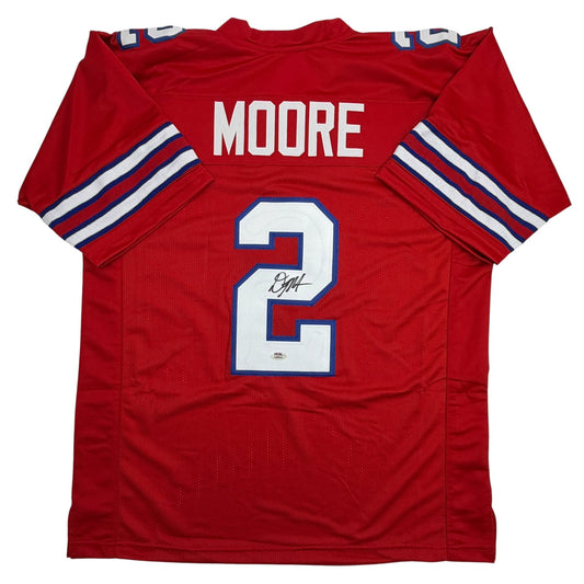 Red football jersey with white number 2, blue trim, "MOORE" nameplate, and signature visible on front.