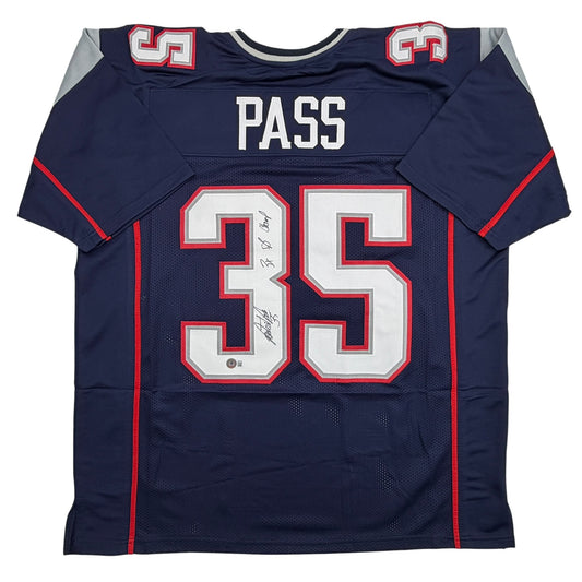 Navy blue football jersey number 35 with "PASS" nameplate, red and white trim, displayed flat against white background with visible autograph on chest.
