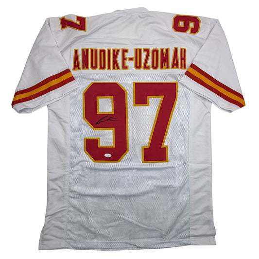 White Kansas City Chiefs football jersey #97 with red and gold lettering showing "ANUDIKE-UZOMAH" and player signature, displayed flat on white background.