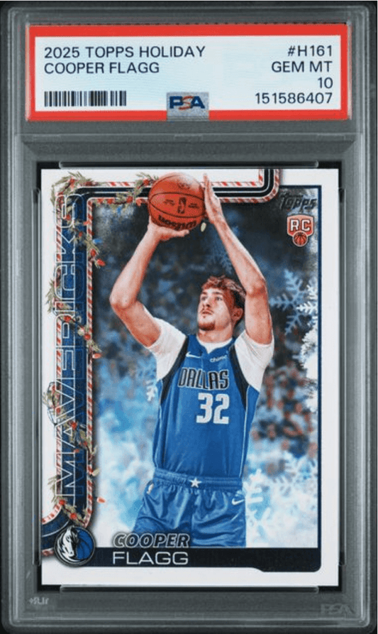 PSA-graded rookie card in clear plastic slab showing Cooper Flagg in Dallas Mavericks blue jersey shooting basketball, with red Topps Holiday border and grading label.