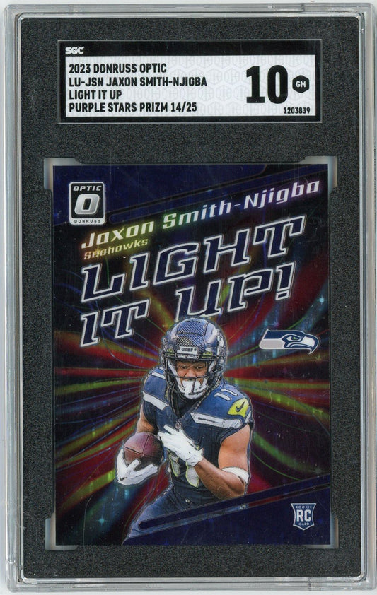 SGC-graded trading card in clear plastic holder showing Seattle Seahawks player Jaxon Smith-Njigba in blue uniform holding football with "Light It Up" text and purple holographic background.