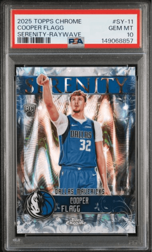 PSA-graded trading card in plastic holder showing Cooper Flagg in Dallas Mavericks blue jersey with holographic Serenity Raywave design.