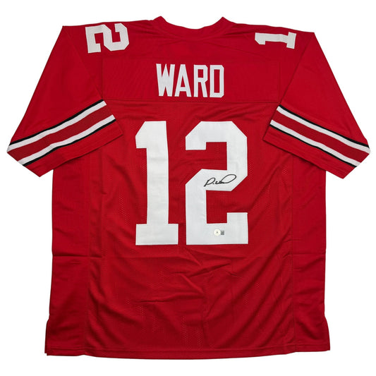 Red Ohio State college football jersey number 12 with "WARD" nameplate, displayed flat, showing front view with white numerals and autograph.