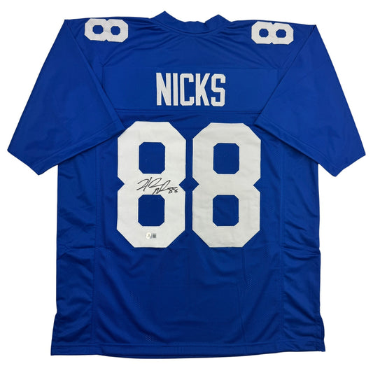 Blue Nicks #88 football jersey displayed flat, showing back with white numbers and autographed signature.
