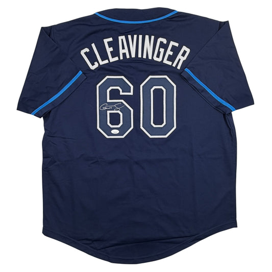 Back view of navy blue baseball jersey with "CLEAVINGER" and number "60" in white lettering, blue trim on neckline and sleeves, autographed.
