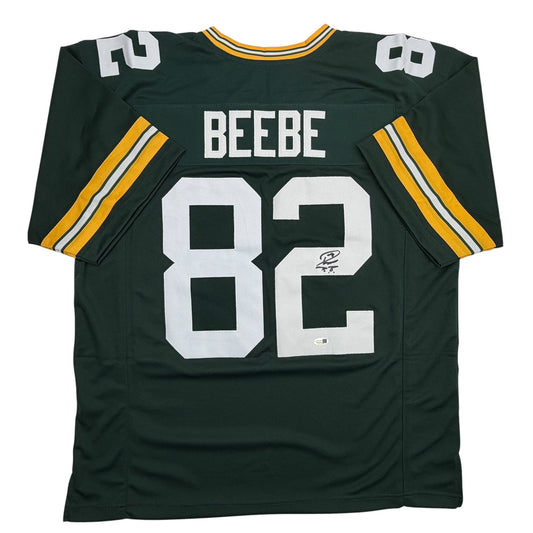 Green Bay Packers football jersey number 82 with "BEEBE" name and autographed signature, displayed flat from front view.