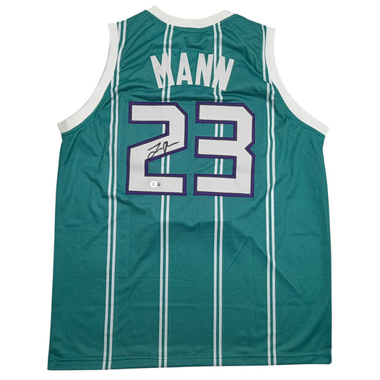 Back view of signed teal Charlotte basketball jersey number 23 with white pinstripes and purple numerals.