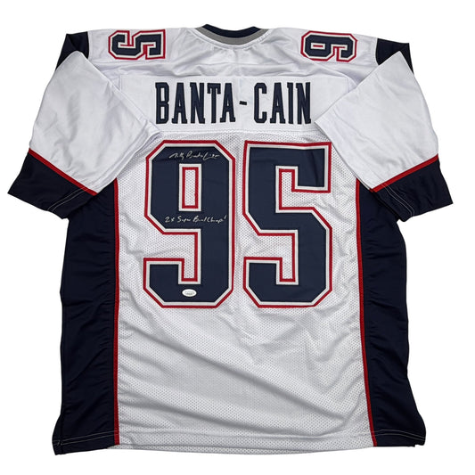 White New England Patriots football jersey number 95 with "BANTA-CAIN" nameplate and black shoulders, displayed flat against white background.