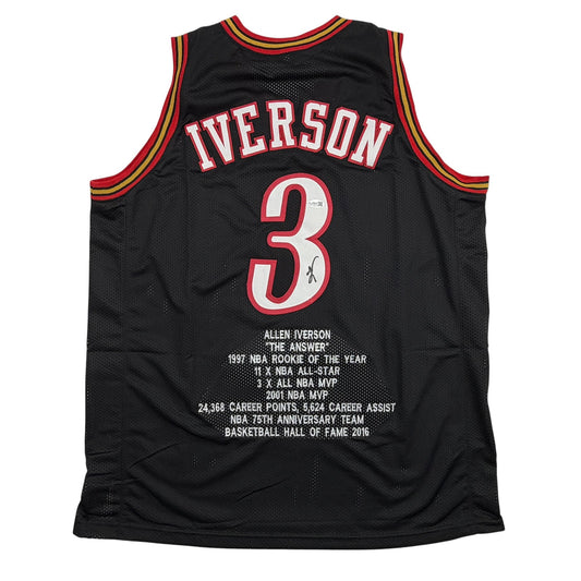 Back view of black Philadelphia 76ers basketball jersey number 3 with "IVERSON" nameplate and white statistical text detailing career achievements.