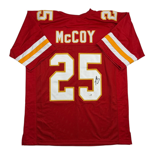 Red Kansas City football jersey with "McCOY" and number 25 displayed, showing front view with gold and white numbering and sleeve stripes.