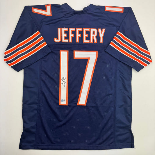 Navy blue Chicago Bears football jersey number 17 with "JEFFERY" name and red/white striping, displayed flat showing back and sleeves with visible autograph.