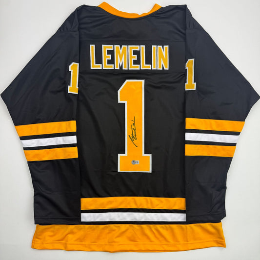 Back view of black Boston Bruins hockey jersey number 1 with "LEMELIN" nameplate and orange striping.