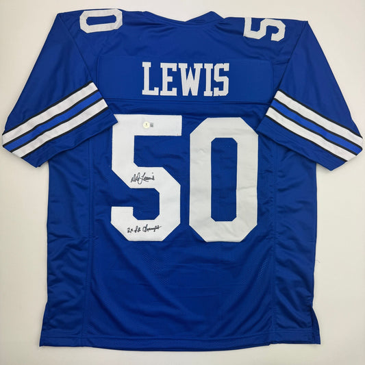 Blue Dallas Cowboys football jersey number 50 with "LEWIS" nameplate and two autographed inscriptions on the back, displayed flat against white background.