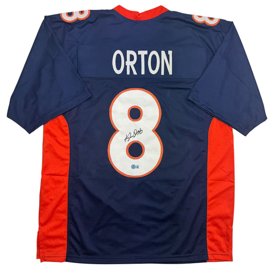 Back view of navy and red Kyle Orton number 8 Denver Broncos football jersey with autograph on white number.
