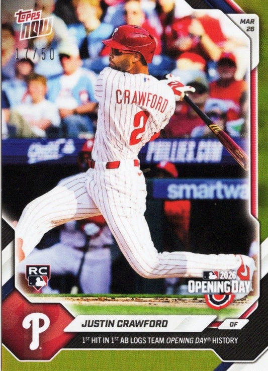 Baseball card front showing Justin Crawford in white pinstriped Phillies uniform mid-swing against blurred stadium background.