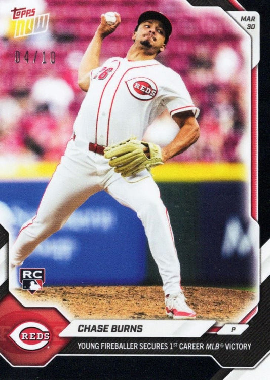 Chase Burns pitching for Cincinnati Reds in white uniform, mid-delivery with baseball, pink background, Topps Now card.