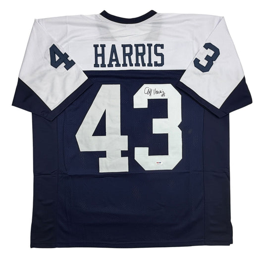 Back view of navy and white Dallas Cowboys football jersey number 43 with "HARRIS" nameplate and autographed signature.