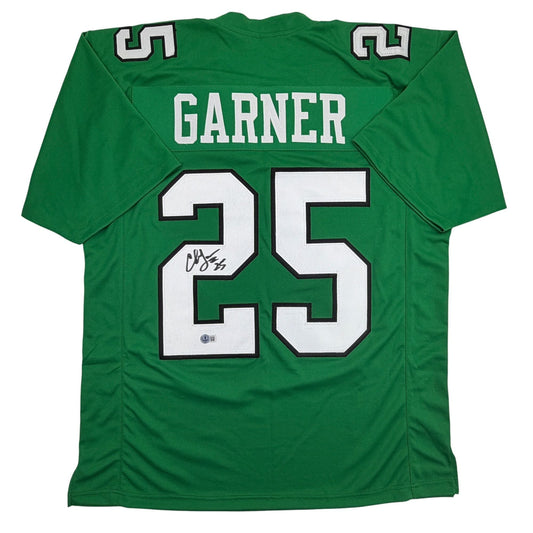 Rear view of signed green Philadelphia football jersey number 25 with "GARNER" nameplate and authentication hologram visible.