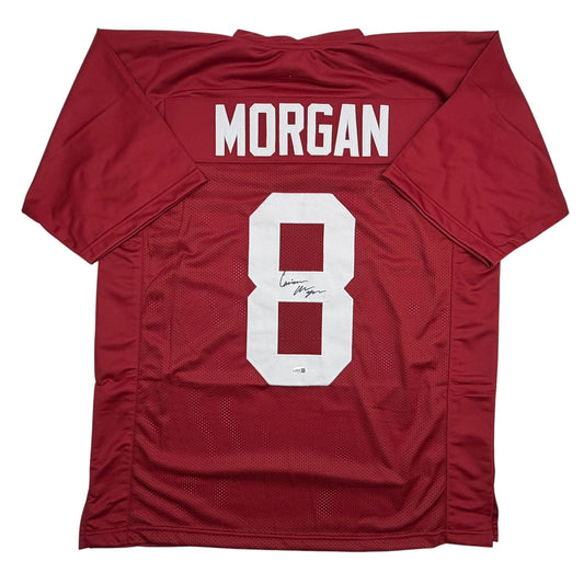 Flat lay of crimson red college football jersey with white "MORGAN" nameplate and number "8" on back.
