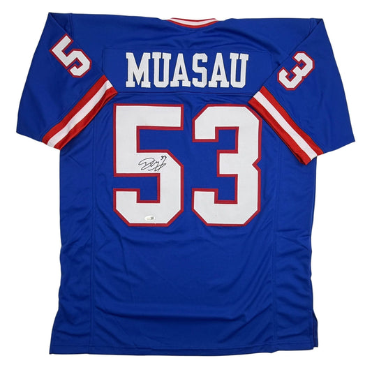 Blue football jersey with "MUASAU" and number 53 in white and red, displayed flat against white background, back view.