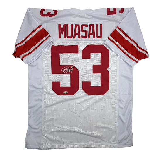 White football jersey with red number 53 and "MUASAU" nameplate, displayed flat with visible autograph on the number.