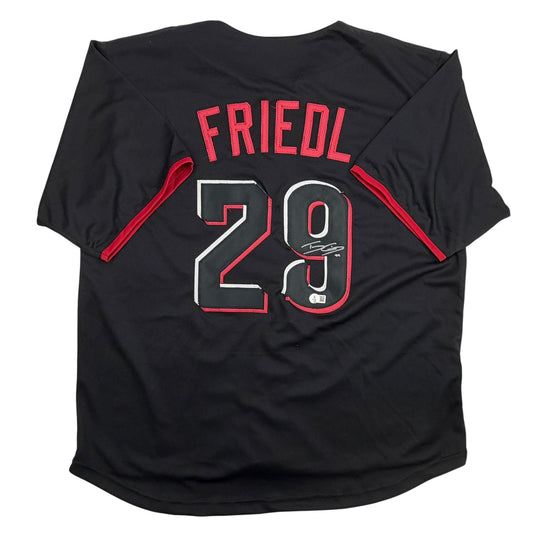 Back view of black baseball jersey with red "FRIEDL" text, number "29" in white and red, and autographed signature visible on chest.