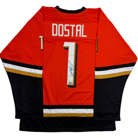 Back view of signed red, black, and gold Anaheim Ducks hockey jersey with DOSTAL and number 1.