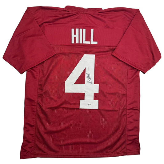 Flat lay of crimson red Alabama football jersey displaying "HILL" nameplate and number "4" with white lettering on back.