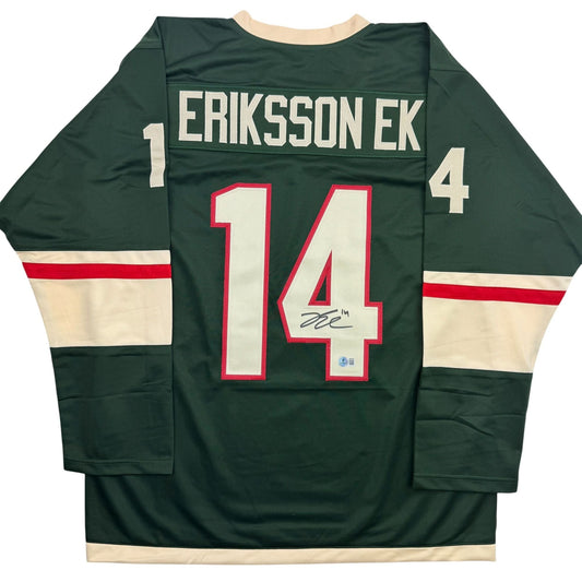 Back view of dark green Minnesota hockey jersey number 14 with "ERIKSSON EK" nameplate and red number with signature.