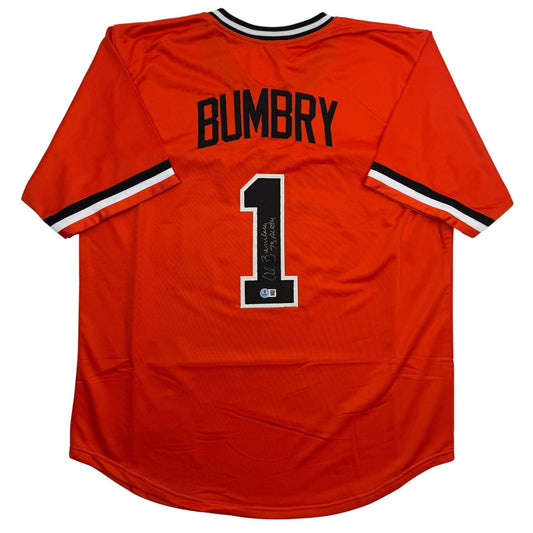 Back view of red baseball jersey displaying "BUMBRY" and number "1" with autographed signature and Beckett authentication sticker.