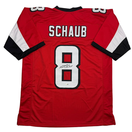 Back view of red, white, and black football jersey displaying "SCHAUB" and number 8 with signature.