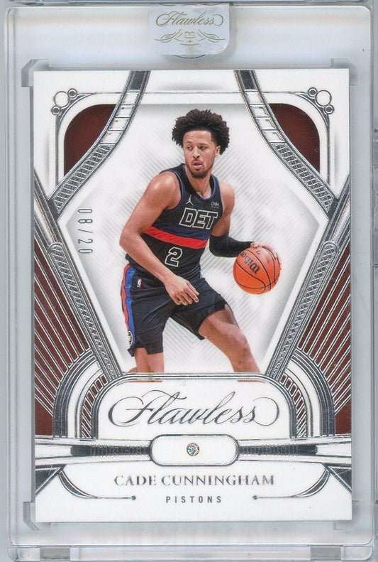 Front of graded basketball card showing Cade Cunningham in Detroit Pistons uniform dribbling ball within ornate silver-bordered frame.