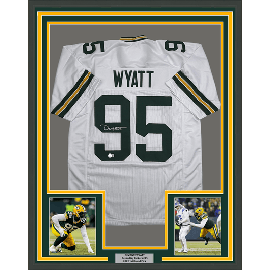 White Green Bay Packers jersey number 95 with "WYATT" nameplate, framed with photos and informational plaque below.