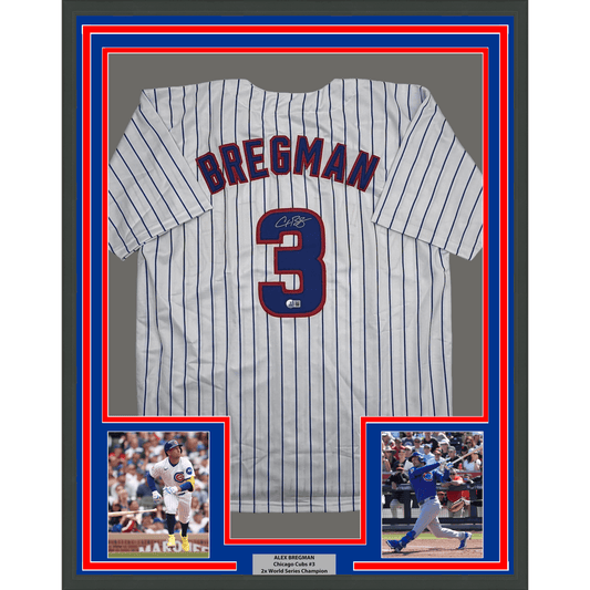Framed white pinstriped baseball jersey displaying "BREGMAN" and number 3 with autograph, flanked by two action photos on blue and red matting.