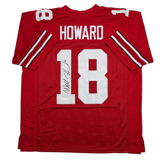Red Ohio State football jersey number 18 with "HOWARD" nameplate and autographed signature on white number, laid flat front view.