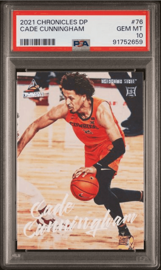 PSA-graded trading card in clear holder showing Cade Cunningham in red jersey dribbling basketball on wooden court.