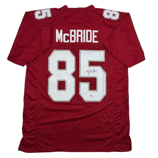 Back view of burgundy football jersey with white "McBRIDE" nameplate and "85" number, autographed.