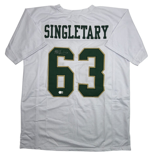 White mesh college football jersey with green and gold number 63, "SINGLETARY" text, and handwritten signature on shoulder.