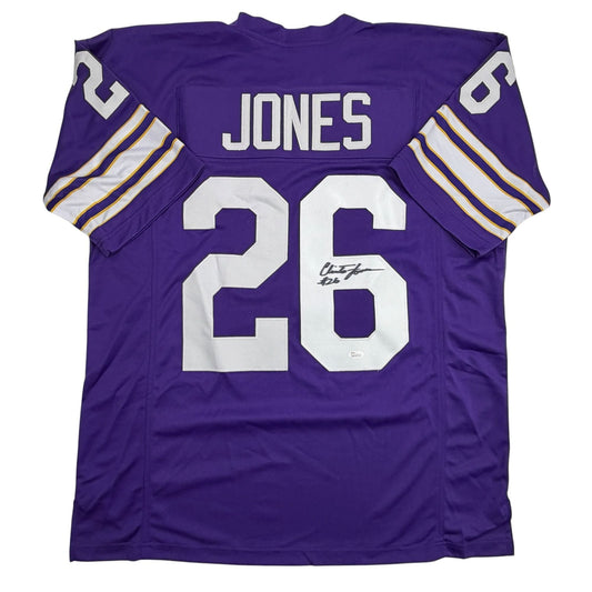 Purple Minnesota Vikings football jersey displaying "JONES" and number 26 on back with white numerals and purple stripe sleeves.
