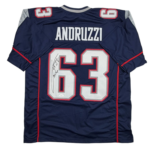 Back view of navy blue New England Patriots jersey number 63 with "ANDRUZZI" nameplate and autographed signature on white and red numerals.