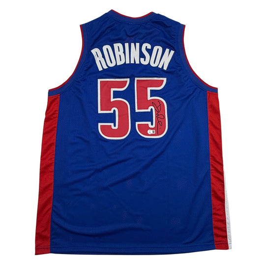 Back view of blue basketball jersey with red sides, displaying "ROBINSON" and number "55" in red with white trim, with autograph on number.