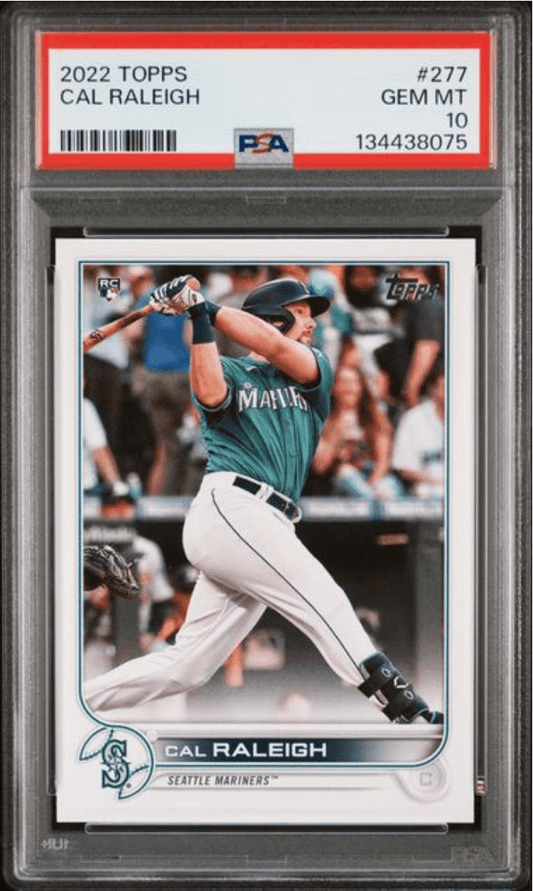 PSA-graded 2022 Topps Cal Raleigh rookie card #277 in protective slab showing player mid-swing in Seattle Mariners uniform.