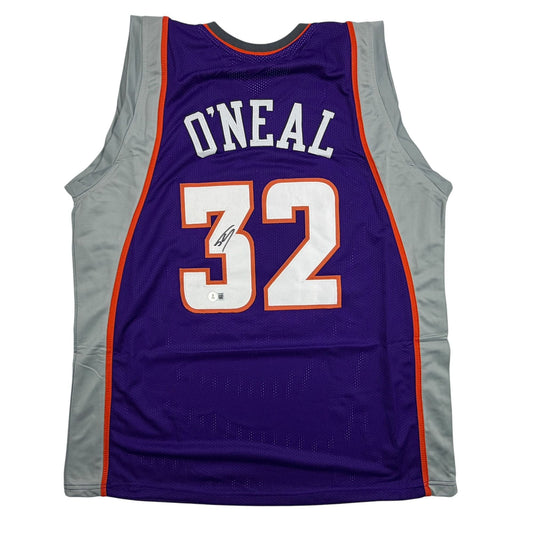 Purple Phoenix Suns basketball jersey number 32 with "O'NEAL" nameplate and autograph, displayed flat against white background.